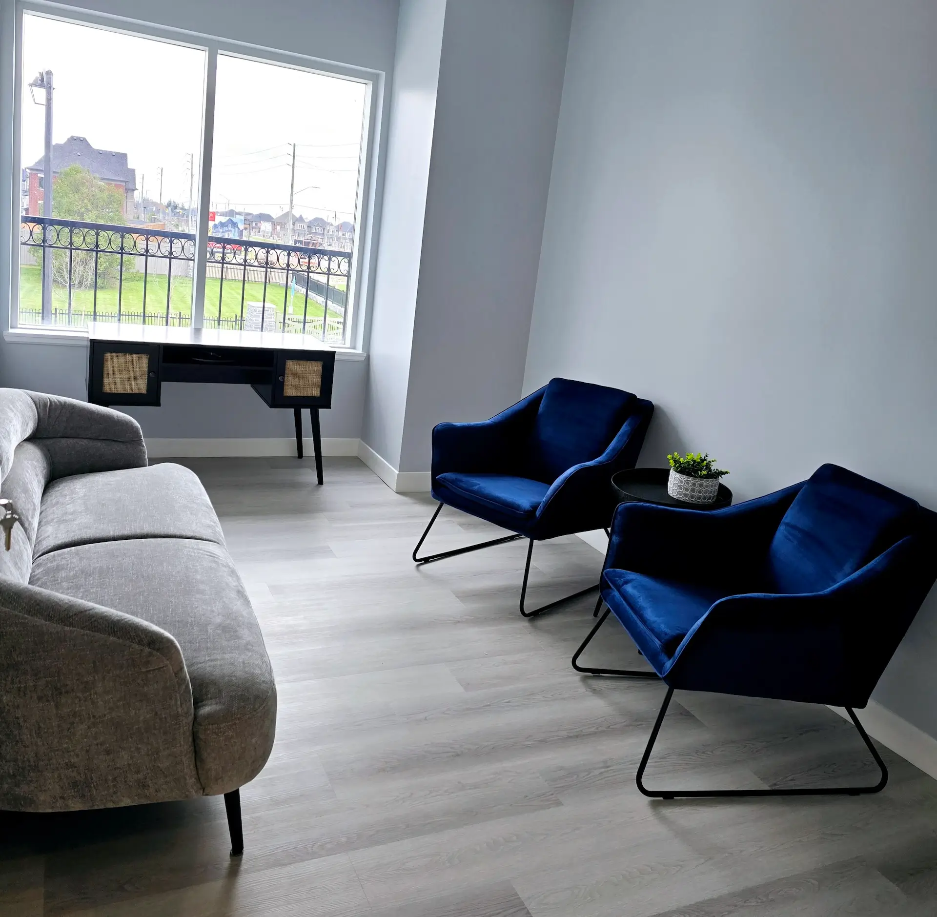 A session room at our Woodbridge office, with two blue armchairs by the window